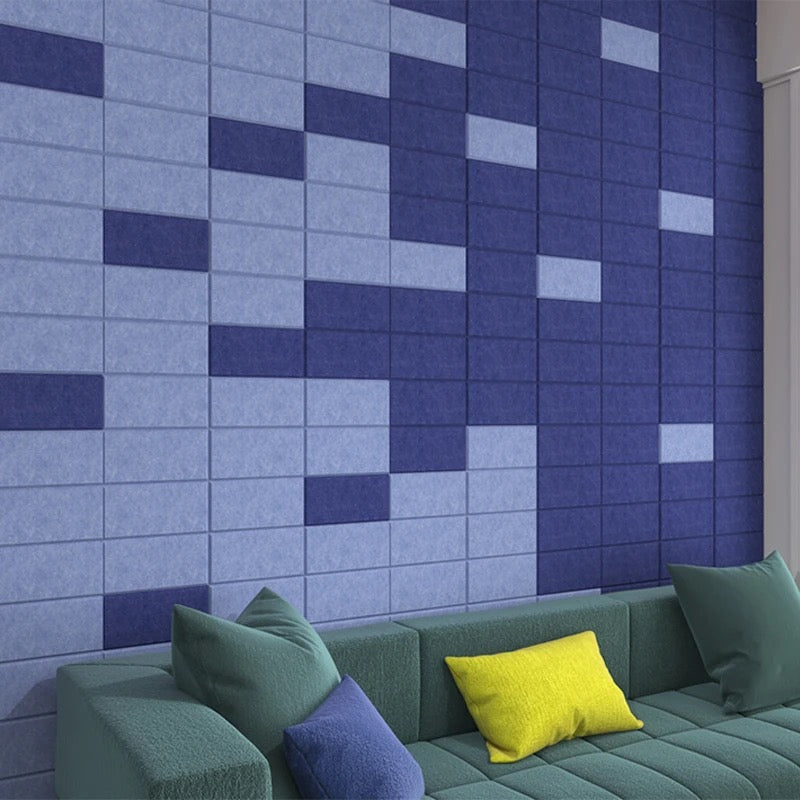 Block PET felt acoustic panels creating modular feature walls with bespoke geometric layouts.